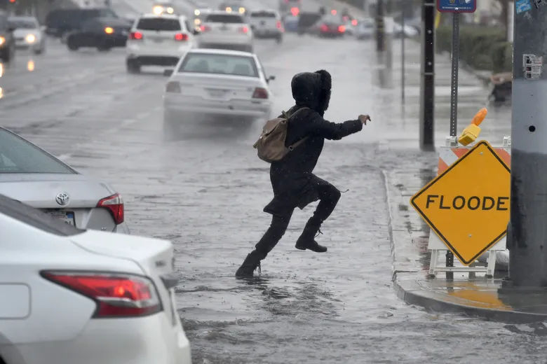 Picture of a person rushing during raining carrying a bag
